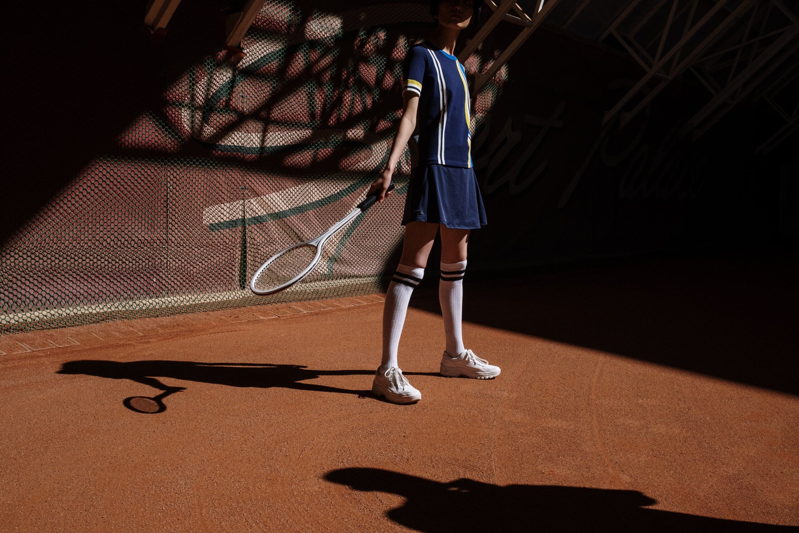 woman playing tennis on a tennis court