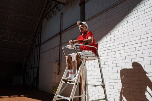 tennis coach sitting on elevated chair