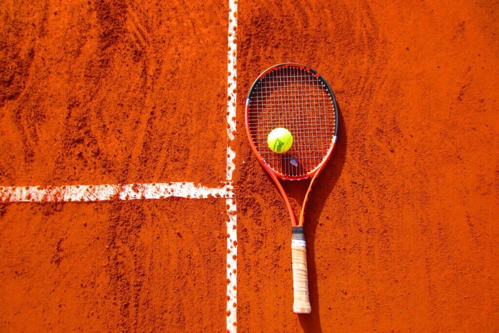 tennis racket and ball on a court